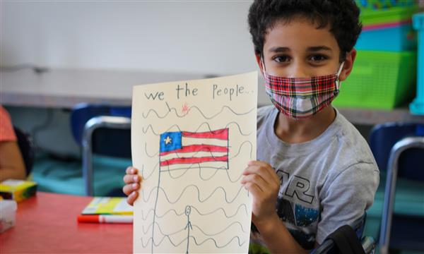 Boy holds up Constitution craft